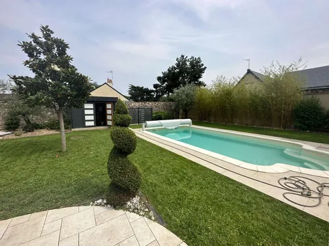 Jardin paysager avec piscine et topiaires parfaitement entretenus